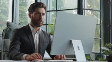 Caucasian busy serious bearded middle-aged 40s man worker in office working online commerce service trade in internet. Adult manager company CEO employee businessman typing on computer concentrated