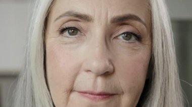 Close up female portrait old lady blonde grey-haired mature woman wise grandma beautiful elder 50s wrinkled housewife pensioner with natural makeup healthy patient of dermatology skincare rejuvenation