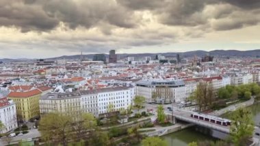Townscape view from above Vienna city capital of Austria european country urban infrastructure red tiles gothic cathedral water Danube canal in cloudy weather horizon metropolis with historical center