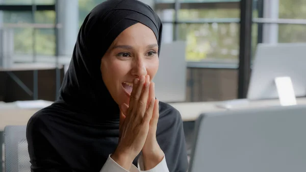 Young excited arab woman checking email on laptop concentration reading gets good news amazed happy businesswoman winner celebrating victory rejoices in success feels joy receives reward career growth