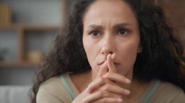 Close up head shot unhappy confused sad worried unhappy suffering Hispanic Latin woman sadness grief female face having psychological problem feeling anxiety frustrated thinking about bad news trouble