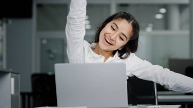 Happy funny cute young woman reading good news on laptop celebrating victory excited with great success gets new opportunities career advancement excellent result of entrance examination to university