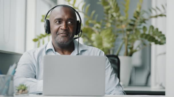 Afrikanischer Lehrer Trägt Kopfhörer Mit Webkamera Zur Kommunikation Mit Kunden — Stockvideo