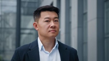 Dalgın rüya gören yönetmen, şehir dışından bakan, ofis binasına bakan, kafasını çeviren, Asyalı, 40 'lı yaşlarda iş adamı bir yatırımcıya bakan, düşünceli bir mimar.