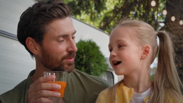 가까이 아버지 수염을 아빠와 여학생 야외에서 야외에서 오렌지 주스를 마시는 — 비디오