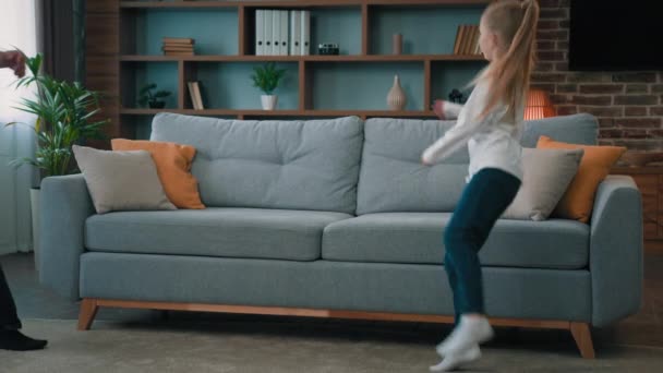 Happy Caucasian Young Family Daddy Child Daughter Jumping Soft Couch — Stock Video