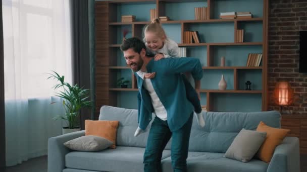 Cheerful Caucasian Father Carrying Blonde Child Girl Back Ride Piggybacking — Stock Video