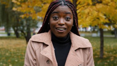 Close-up stunned african american woman standing outdoor looking at camera with eyes wide open and mouth feeling shock surprise from unexpected news amazed young female shocked expression feels wonder