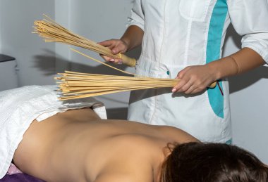 professional physiotherapist doing massage with a young woman in a spa center