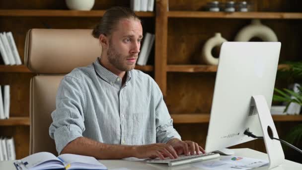 Upset American businessman, manager or freelancer, sitting at a desk in the office, have a stressful situation, failed, lost money, sad facial expression – Stock-video