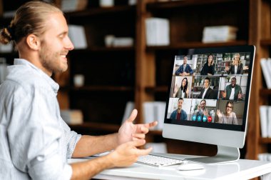 Farklı milletlerden meslektaşlarıyla video konferansında konuşan başarılı bir beyaz adam, proje ve stratejiyi tartışıyor. Çevrimiçi iş toplantısı, çalışanların beyin fırtınası.