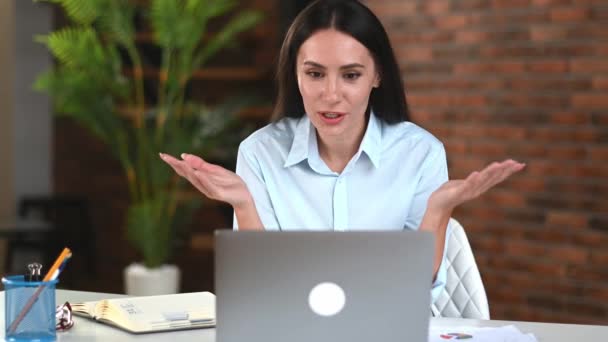 Beautiful successful caucasian business lady, freelancer, manager, using laptop, talking on video conference with client or associate, discussing business project, gesturing with hand, smiles — Stok Video