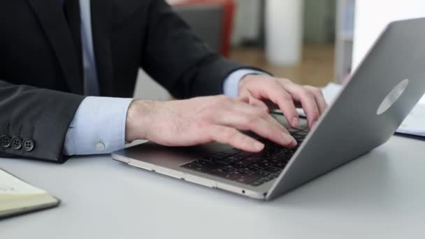 Widok z bliska męskich rąk wpisujących na klawiaturze laptopa. Kaukaski biznesmen korzystający z laptopa podczas pracy online w nowoczesnym biurze, przeglądanie Internetu, SMS-y online, pisanie tekstu — Wideo stockowe