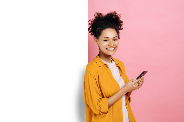 Pretty African American Curly Girl Uses Smartphone Browsing Social Media Stock Picture