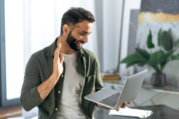 Successful Arabian Indian Man Holds Using Laptop While Stand Modern Stock Photo