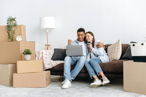Real Estate Concept Happy Mixed Race Family Couple Sitting Sofa Stock Image