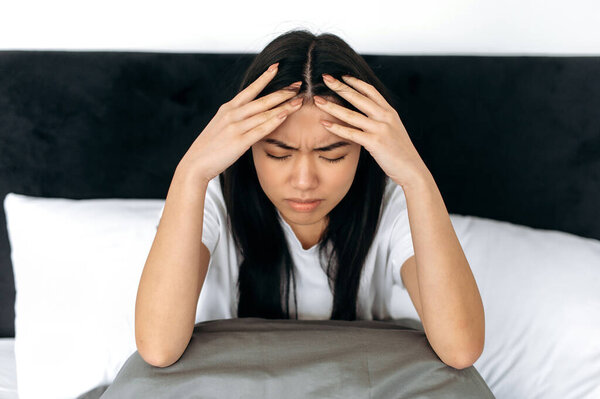 Depressed Apathy Headache Unhappy Chinese Japanese Brunette Girl Sitting Bed Royalty Free Stock Photos