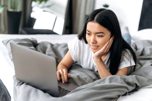 Pretty Positive Asian Brunette Girl White Shirt Lying Bed Home Stock Image