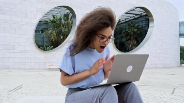Joyful Excited African American Young Woman Glasses Uses Laptop While — 图库视频影像