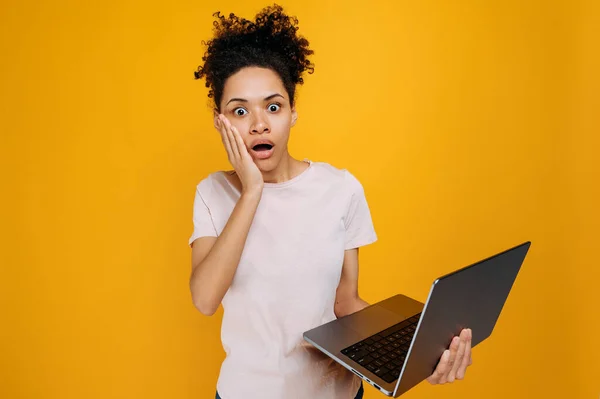 Shocked African American Young Woman Curly Hair Holds Open Laptop — Stok fotoğraf