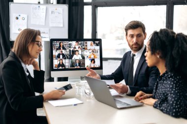 Group cooperation by video call. Business multiracial colleagues, discussing new project, generating new ideas, communicating via video conference with their business partners from different countries