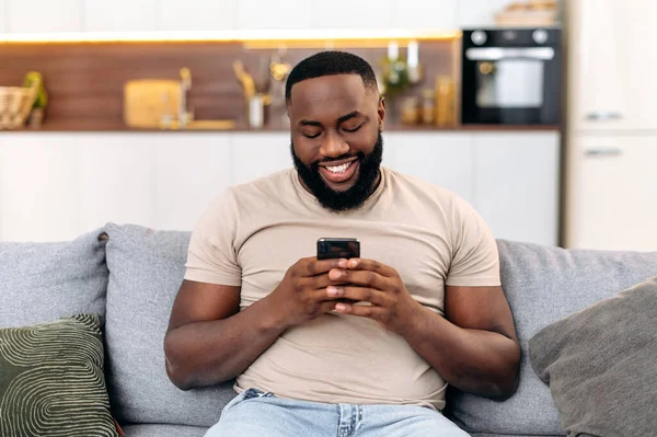 Modern Attractive Positive African American Man Casual Wear Sits Home — Fotografia de Stock