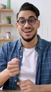 Vertical video of friendly indian or arabian man, business leader or coach, conducts business meeting with colleagues, holds a speech of ideas and promotion, talks about strategy,records online lesson