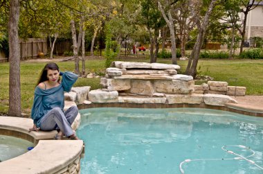 Beautiful Hispanic Woman by Swimming Pool clipart