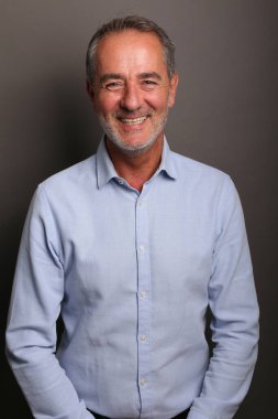 Güzel, mutlu bir adamın portresi. Renkli bir arka planın önünde.