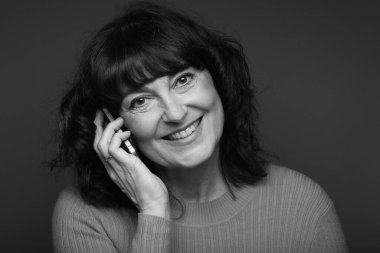 Güzel, mutlu bir kadının portresi. Renkli bir arka planın önünde.