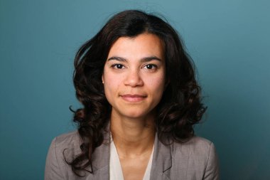 Güzel, mutlu bir kadının portresi. Renkli bir arka planın önünde.