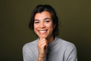 Güzel, mutlu bir kadının portresi. Renkli bir arka planın önünde.