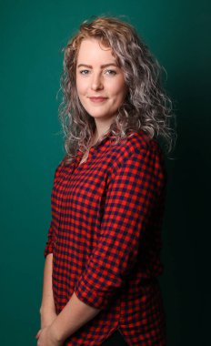 Güzel, mutlu bir kadının portresi. Renkli bir arka planın önünde.