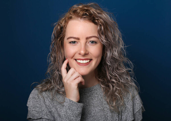 Portrait of a beautiful happy woman in front of a colored background