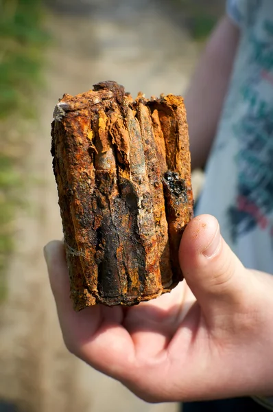 Old rusty cartridge in hand — Stock Photo, Image