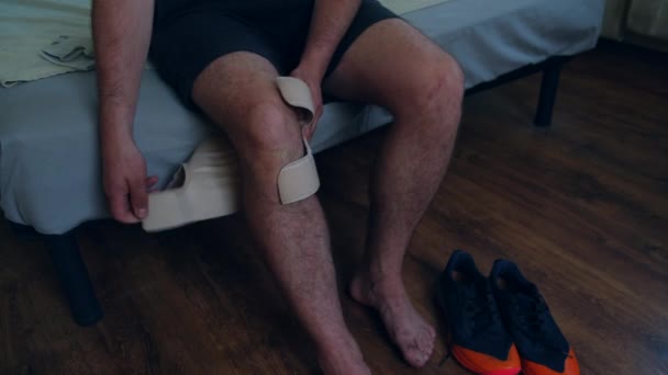 Man Removes Knee Brace Playing Active Sports Football Tennis Volleyball — Stock Video