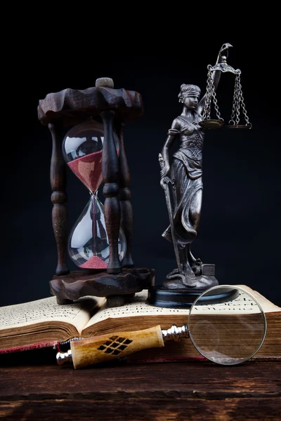 Old book temida statue and magnifying glass — Stock Photo, Image