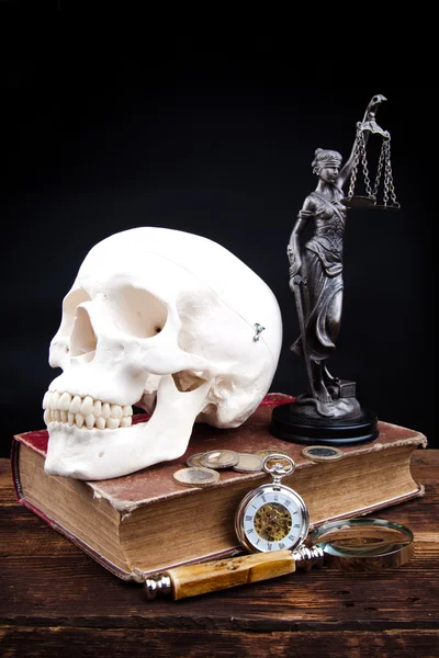 Old book temida statue and magnifying glass — Stock Photo, Image