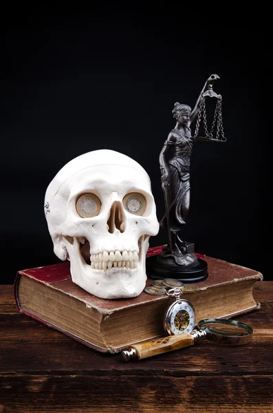 Old book temida statue and magnifying glass — Stock Photo, Image