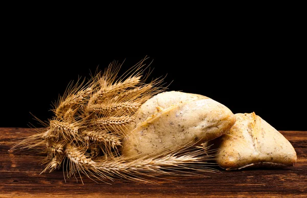 Baked bread on wooden table — Stock Photo, Image