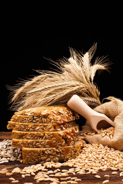 Baked bread on wooden table — Stock Photo, Image