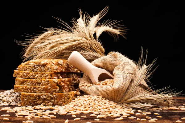 Baked bread on wooden table — Stock Photo, Image