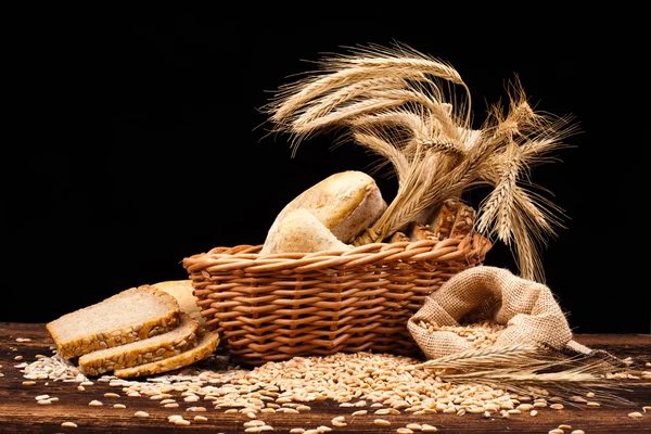 Baked bread on wooden table — Stock Photo, Image