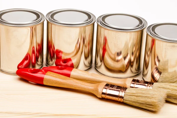 Cans of paint with paintbrushes isolated on white — Stock Photo, Image