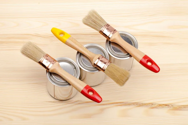 Cans of paint with paintbrushes isolated on white — Stock Photo, Image