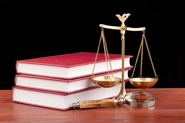 Law books, money , magnifying glass and scales of justice — Stock Photo, Image