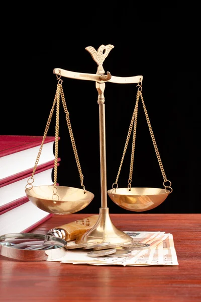 Law books, money , magnifying glass and scales of justice — Stock Photo, Image