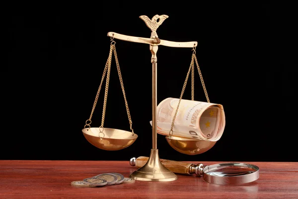 Law books, money , magnifying glass and scales of justice — Stock Photo, Image