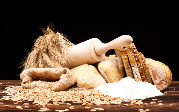 Baked bread on wooden table — Stock Photo, Image