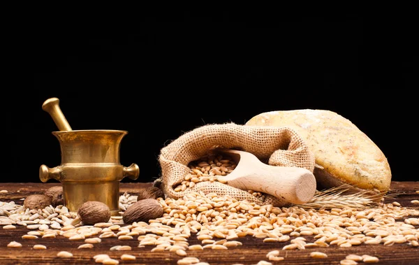 Baked bread, wheat and brass mortar — Stock Photo, Image